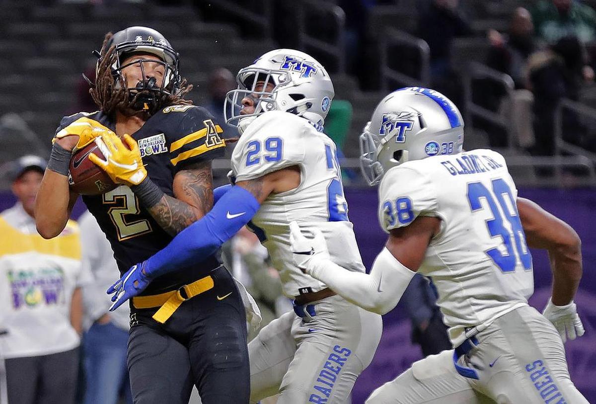 Appalachian State wide receiver Corey Xavier Sutton, left, the former Mallard Creek High standout, catches a touchdown pass against Middle Tennessee cornerback Darryl Randolph (29) and safety Kendricks Gladney (38) in the second half of the New Orleans Bowl on Saturdary. Appalachian State won 45-13.