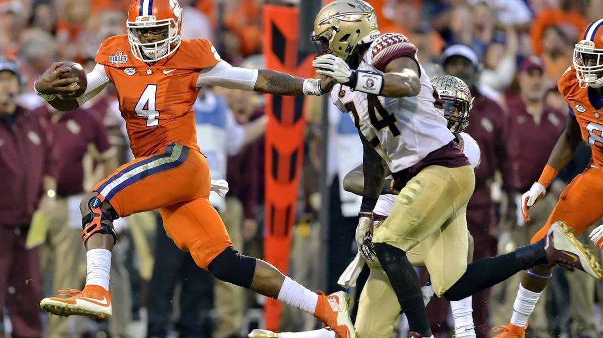 Clemson quarterback Deshaun Watson (4) fends off Florida State's Terrance Smith to gain a first down during the first half of an NCAA college football game in Clemson, S.C. on Nov. 7, 2015.