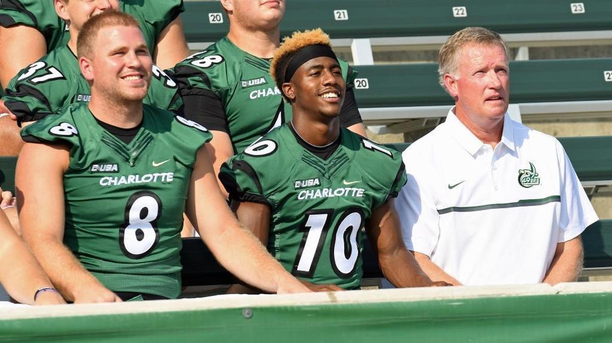 Charlotte seniors Matt Johnson, left, Austin Duke and coach Brad Lambert return for the program’s fourth season, which kicks off Thursday night at No. 19 Louisville. It will be Charlotte’s first game against a Top 25 opponent.