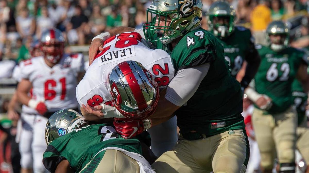 Charlotte 49ers linebacker Jeff Gemmell tackles Western Kentucky tight end Kris Leak in a Conference USA football game earlier this season at Richardson Stadium.