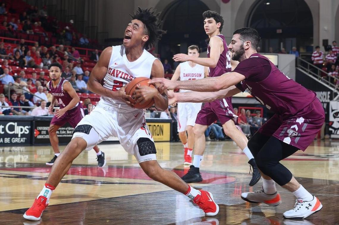Joseph Chartouny (12) of Fordham tries to steal the ball from Carter Collins (24) of Davidson. The Davidson Wildcats beat the visiting Fordham Rams 76-52 Wednesday night at Belk Arena.