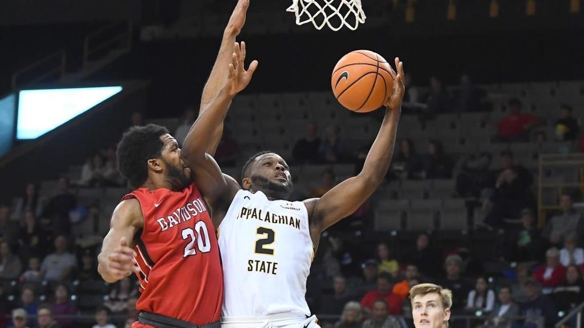 Appalachian State’s Ronshad Shabazz (02) scores two of his game-high 18 points past Davidson's KiShawn Pritchett (20) late in the first half of non-conference basketball action at the Holmes Center on Saturday, Nov. 25, 2017 in Boone. Appalachian State won 78-62.