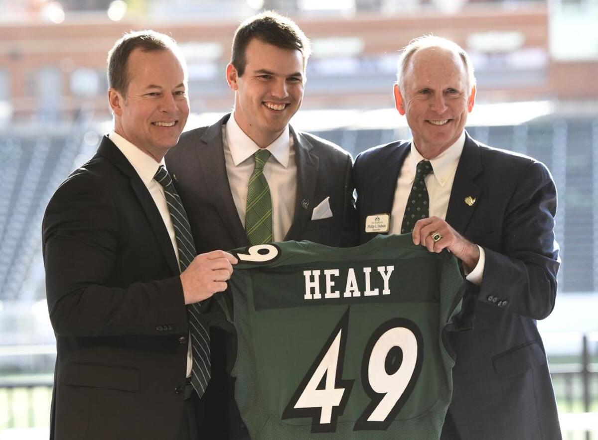 New Charlotte 49ers football coach Will Healy, center, is joined by athletics director Mike Hill, left, and Chancellor Phil Dubois during Healy’s introductory news conference in early December.