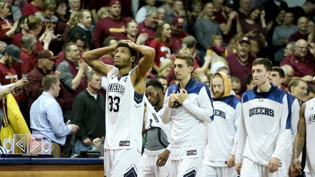 Queens senior Todd Withers (33) walks with his team off the court at the end of Thursday night’s semifinal game in the NCAA Division II Men's Basketball Championship tournament at the Sanford Pentagon in Sioux Falls, South Dakota. The Royals fell 105-99 in two overtimes.