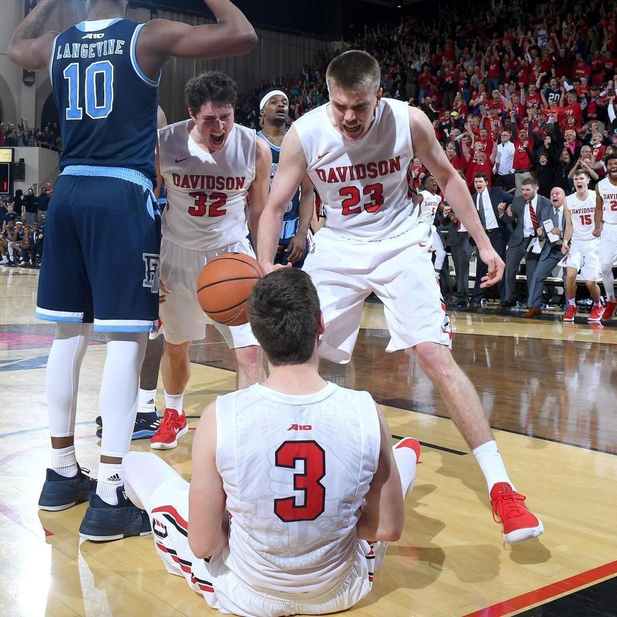 Davidson's Peyton Aldridge (23) and Rusty Reigel (32) celebrate Jon Axel Gudmundsson's (03) three-point play with 3.1 seconds left in the game for Friday’s upset win against Atlantic 10 leader Rhode Island.