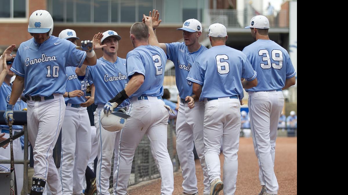 
North Carolina’s Adam Pate (2) is welcomed to the dugout after scoring to give the Tar Heels’ a 2-1 lead against Virginia Tech in the bottom of the fourth inning on a single by Logan Warmoth (7) during the ACC Baseball Championship on Tuesday at the Durham Bulls Athletic Park in Durham.
