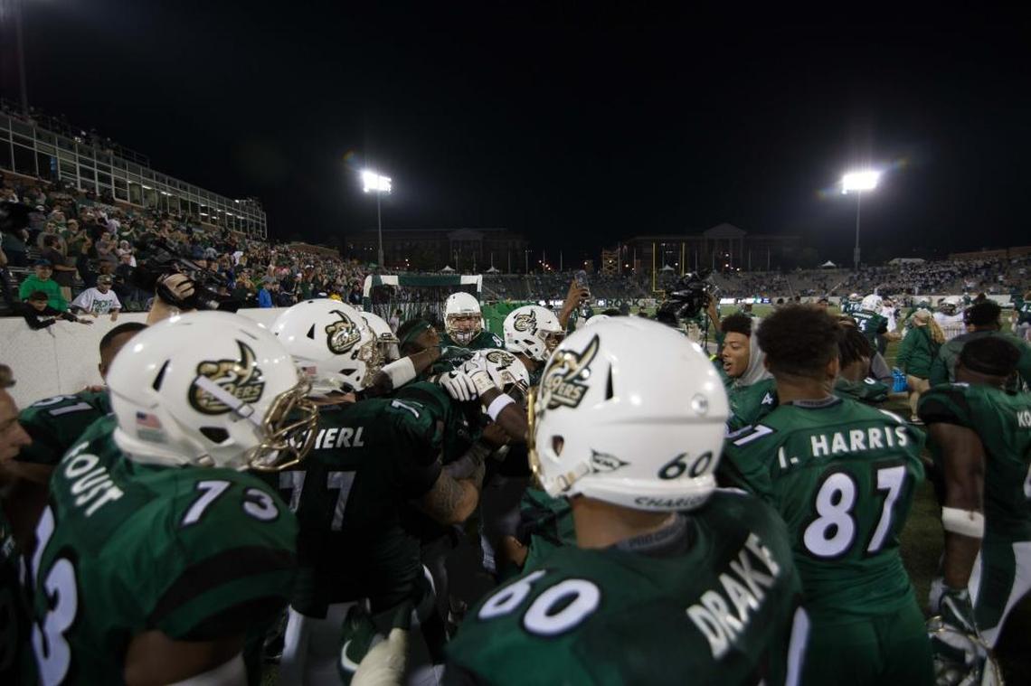 The Charlotte 49ers congratulate quarterback Hasaan Klugh, who scored the game-winning points Saturday by catching a flea-flicker pass on a two-point conversion in overtime. Klugh scored the final touchdown on a 1-yard scoring run in the 25-24 win against Ala.-Birmingham.