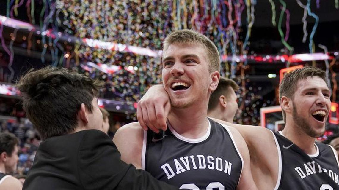 Davidson forward Peyton Aldridge (23), second from left, Davidson guard Jon Axel Gudmundsson (3), right, and others celebrate Sunday’s Atlantic 10 Conference tournament championship win against No. 25 Rhode Island in Washington. The Wildcats stunned the top-seeded Rams 58-57 to win their first-ever A-10 title along with an automatic NCAA Tournament bid.