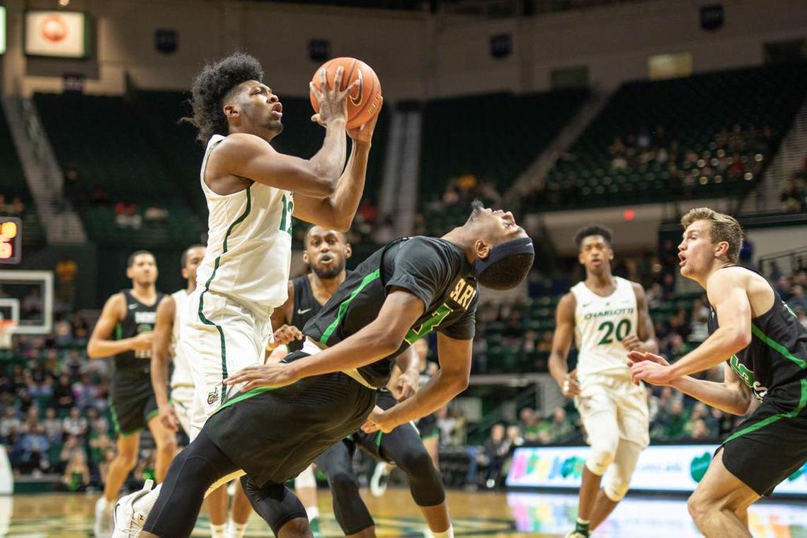 Charlotte 49ers freshman guard Malik Martin, left, charges into North Texas’ Roosevelt Smart during Saturday’s Conference USA men’s basketball game at Halton Arena. North Texas won73-66.
