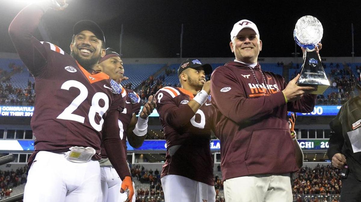 Virginia Tech coach Justin Fuente holds the 2016 Belk Bowl trophy after the Hokies beat Arkansas 35-24 at Bank of America Stadium in December.