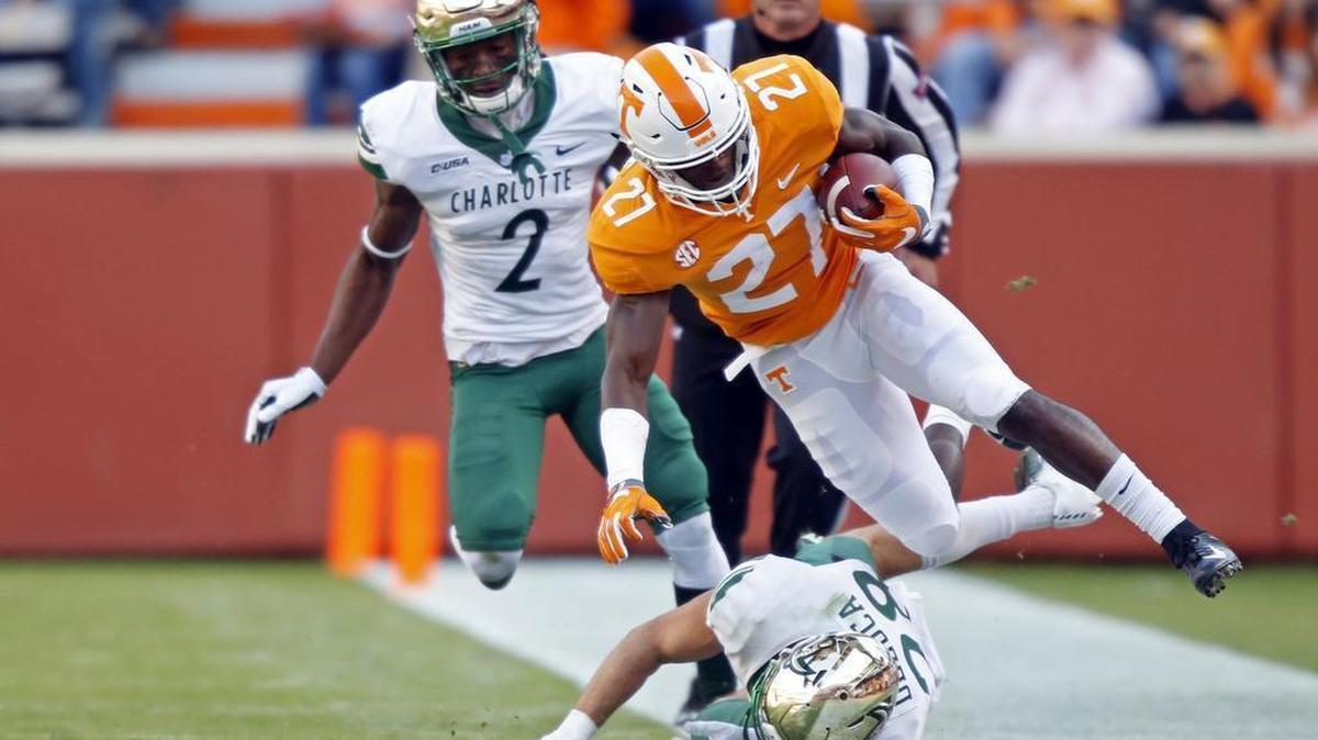 Tennessee’s Carlin Fils-aime (27) is knocked out of bounds by Charlotte defensive back Ben DeLuca (28) in the first half of Saturday’s college football game in Knoxville, Tenn. Charlotte defensive back Ed Rolle (2) is also in the play.