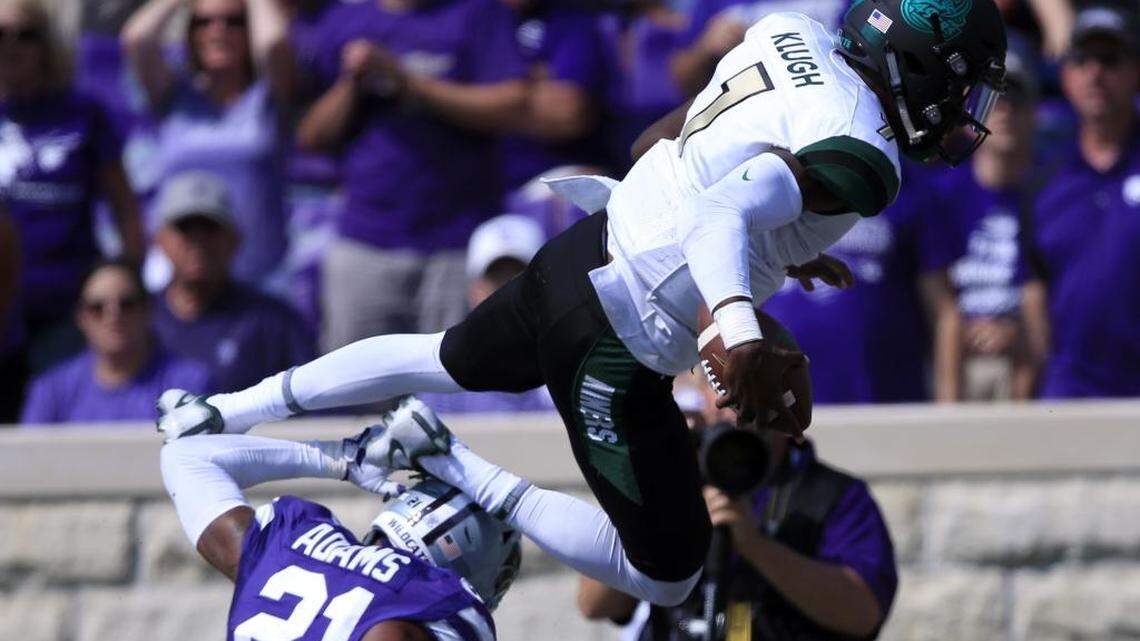 Charlotte quarterback Hasaan Klugh (7) dives over Kansas State defensive back Kendall Adams (21) for a touchdown during Saturday’s game in in Manhattan, Kan. The Wildcats rolled, 55-7, as turnovers cost the 49ers dearly.