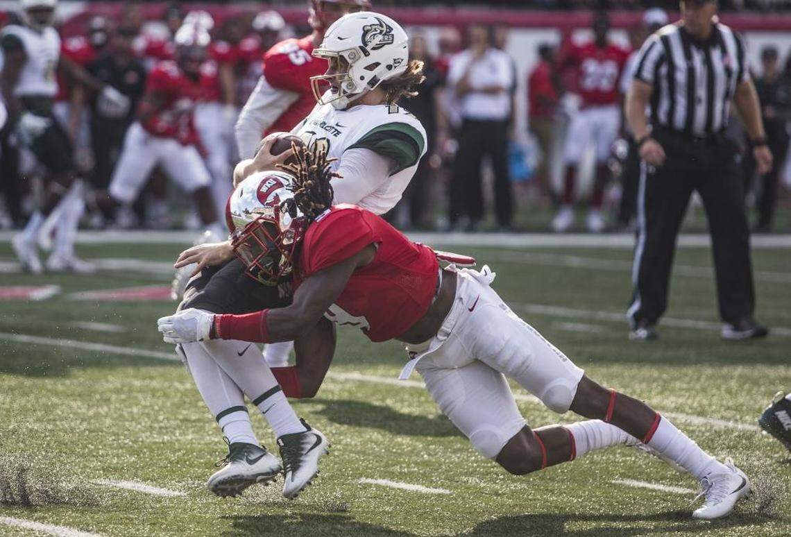 Western Kentucky defensive back Drell Greene, bottom, tackles Charlotte 49ers quarterback Brooks Barden (12) during Saturday’s game in Bowling Green, Ky.