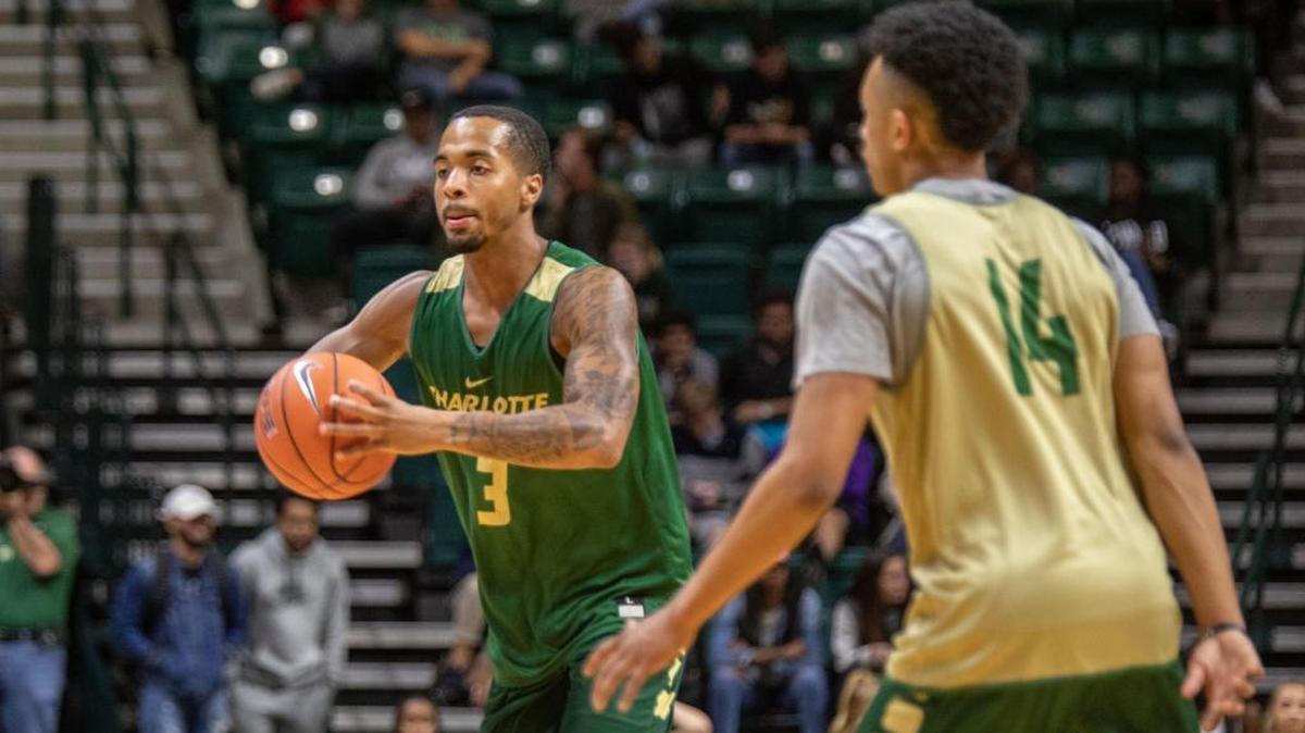 Charlotte 49ers point guard Jon Davis, left, who earlier in the day was named to the All-Conference USA preseason men’s team, tosses a pass to teammate during Thursday night’s Basketball Madness at Halton Arena.