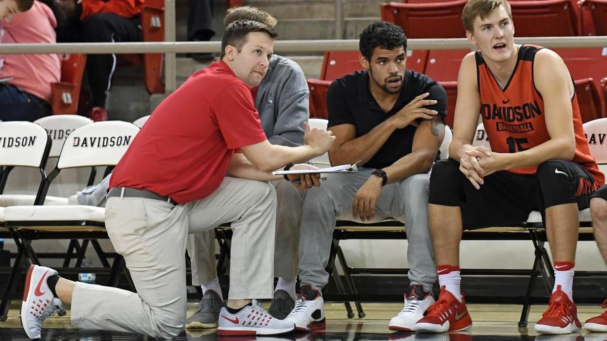 Davidson senior guard Jack Gibbs (center) talks with assistant coach Ryan Mee (left) and teammate Oskar Michelsen during the Wildcats’ Red-Black Scrimmage on Saturday. Gibbs, Davidson’s leading scorer last season at 23.5 points, injured his left shoulder at practice Thursday and will be sidelined 2-4 weeks.