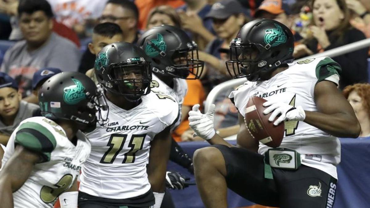 Charlotte's Juwan Foggie, right, celebrates after he scored on a bobbled punt attempt during Saturday’s game in San Antonio. Though they lost Saturday, the 49ers made strides this season, doubling their victory total and winning three conference games.