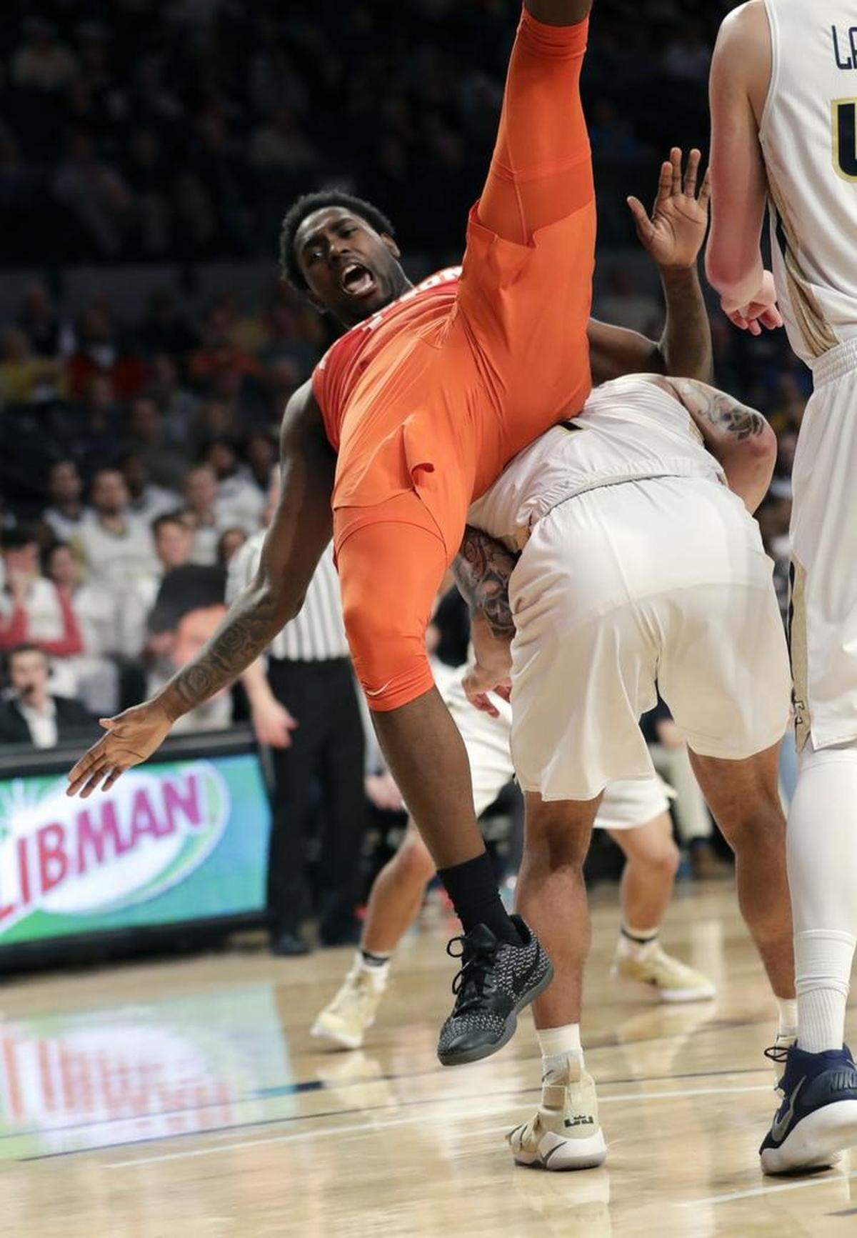 Clemson forward Elijah Thomas (14) falls over a Georgia Tech player in the first half of Sunday’s game.