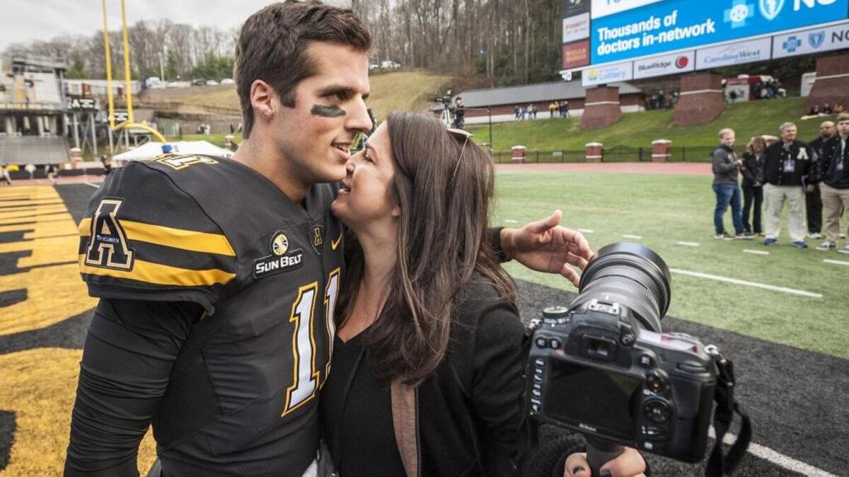 Appalachian State senior quarterback Taylor Lamb hugs his mother, Allyson Lamb, after pregame warmups for the Mountaineers' football game against Louisiana on Saturday.