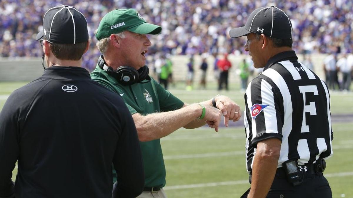 Charlotte football coach Brad Lambert (center) will lead the 49ers against Florida International on Saturday.