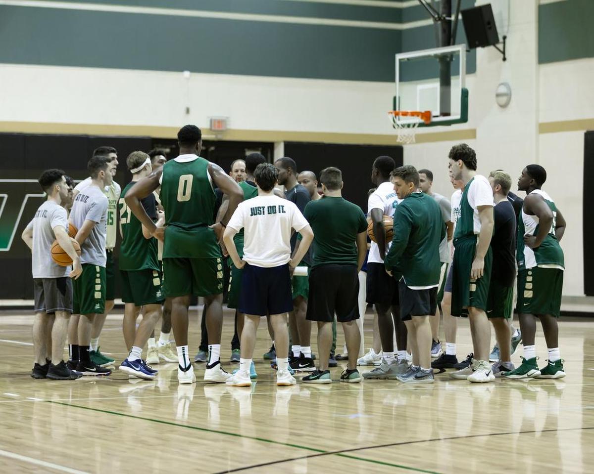 First-year head coach Ron Sanchez gives instructions to his team during the Charlotte 49ers’ first practice of the season.