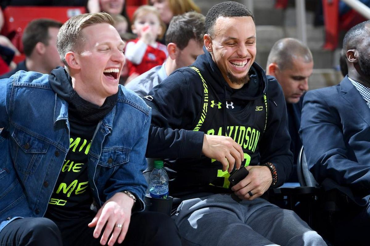 Golden State Warriors All-Star Stephen Curry, right, the former Davidson Wildcats star, shares a laugh with fellow alum Bryant Barr Friday night at Davidson. The Wildcats beat Saint Joseph’s 80-72 in the Atlantic 10 men’s basketball game at Belk Arena..
