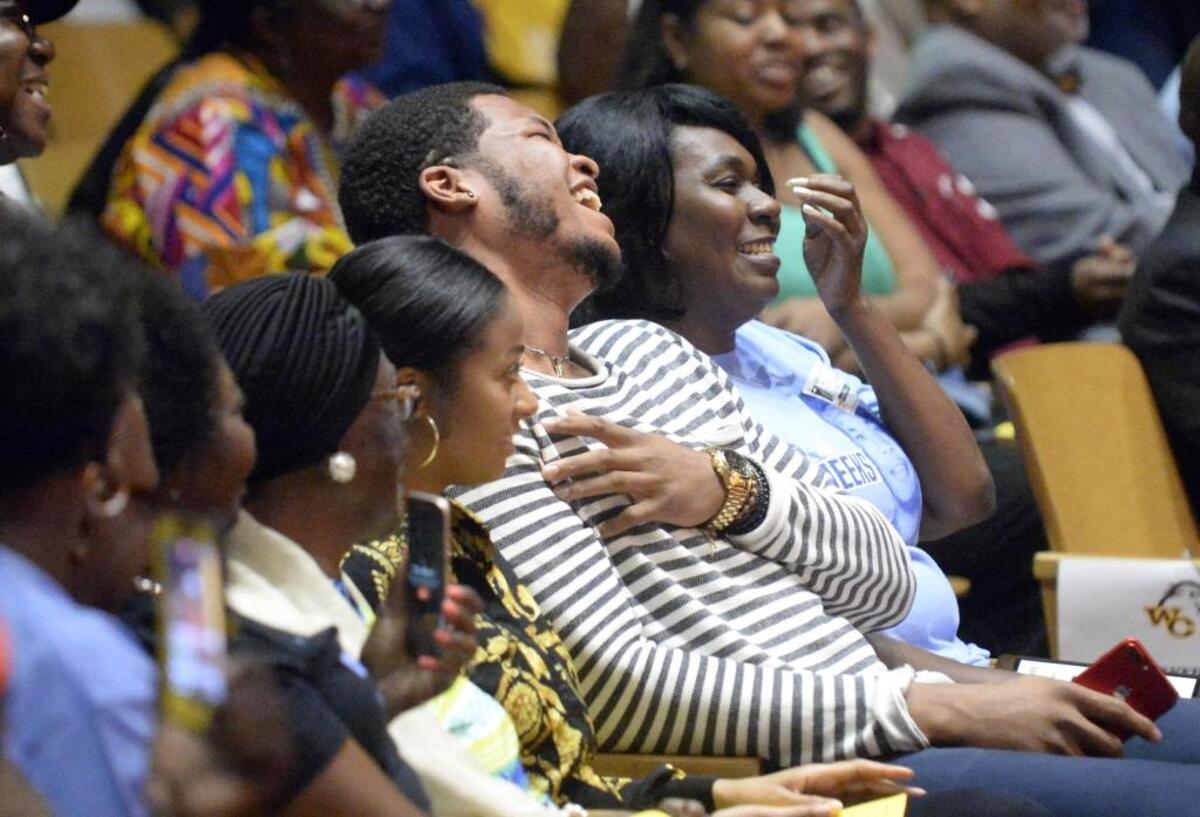 Kennedy Meeks, center, laughs while listening to a former coach talk about him as a West Charlotte High student during “Kennedy Meeks Day” at the school. In April, Meeks helped lead the North Carolina Tar Heels to the NCAA men’s basketball championship.