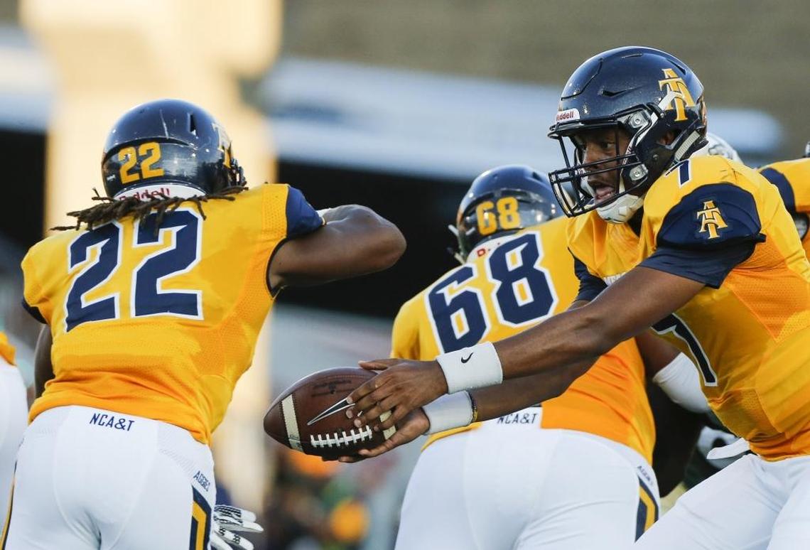 North Carolina A&T quarterback Lamar Raynard (7) hands the ball off to running back Marquell Cartwright (22) while facing the Charlotte 49ers during Saturday’s game at Jerry Richardson Stadium.