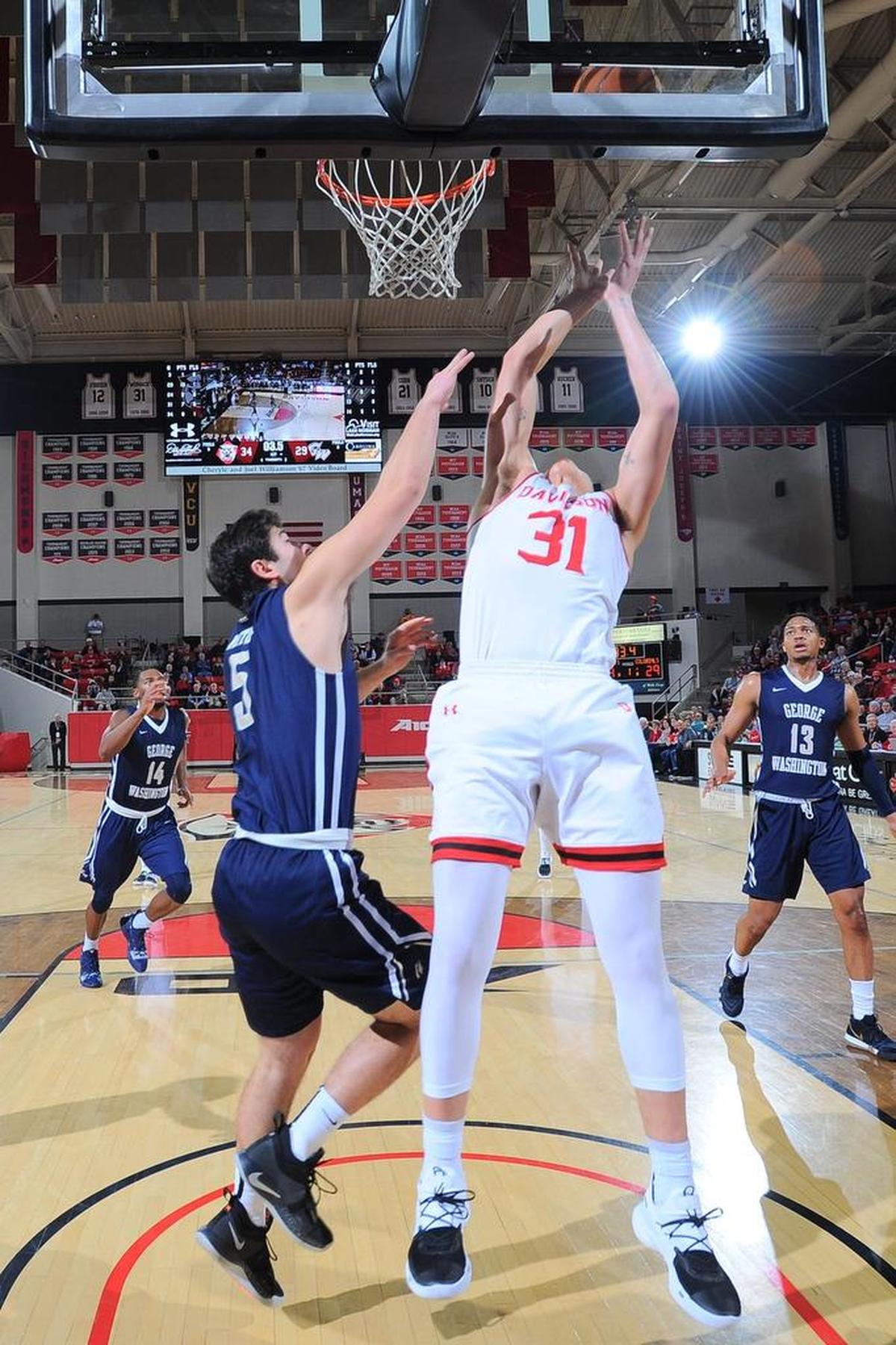 Davidson sophomore guard Kellan Grady (31) drives and scores at the buzzer against George Washington’s Adam Mitola in the first half of Wednesday night’s Atlantic 10 men’s basketball game at Belk Arena. Grady finished with 16 points.