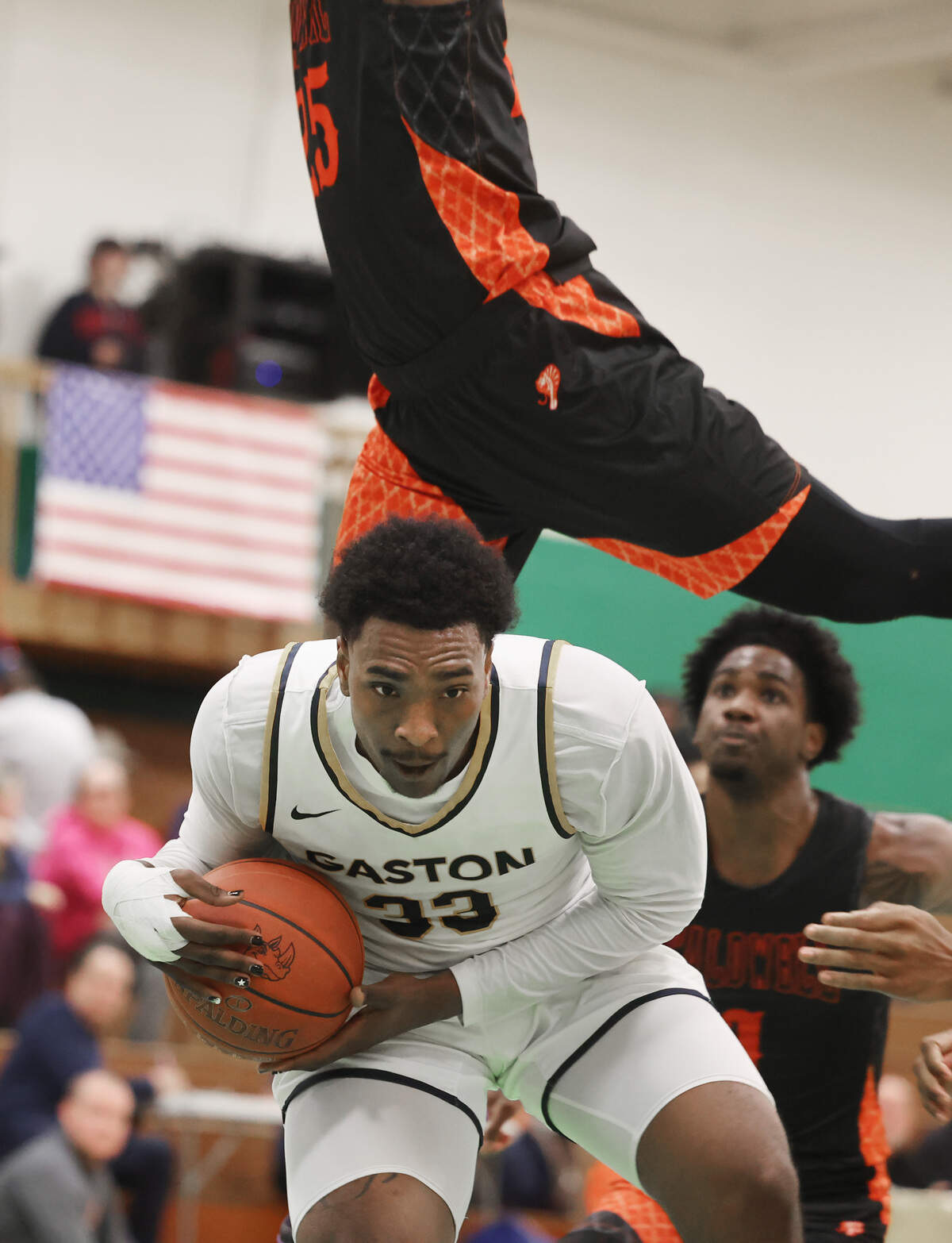 Kaleb Siler, a center for Gaston College, avoids Caldwell Community College and Technical Institute forward Jaylen Golston on Jan. 21, 2026, at Ashbrook High School in Gastonia.