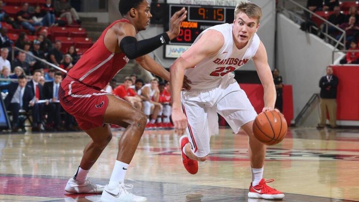 Davidson senior Peyton Aldridge (right) drives against Saint Joseph's Pierfrancesco Oliva late in first half of Tuesday’s Atlantic 10 men’s basketball game at Belk Arena Tuesday night. Aldridge scored a game-high 32 points in the Wildcats’ 91-62 victory.