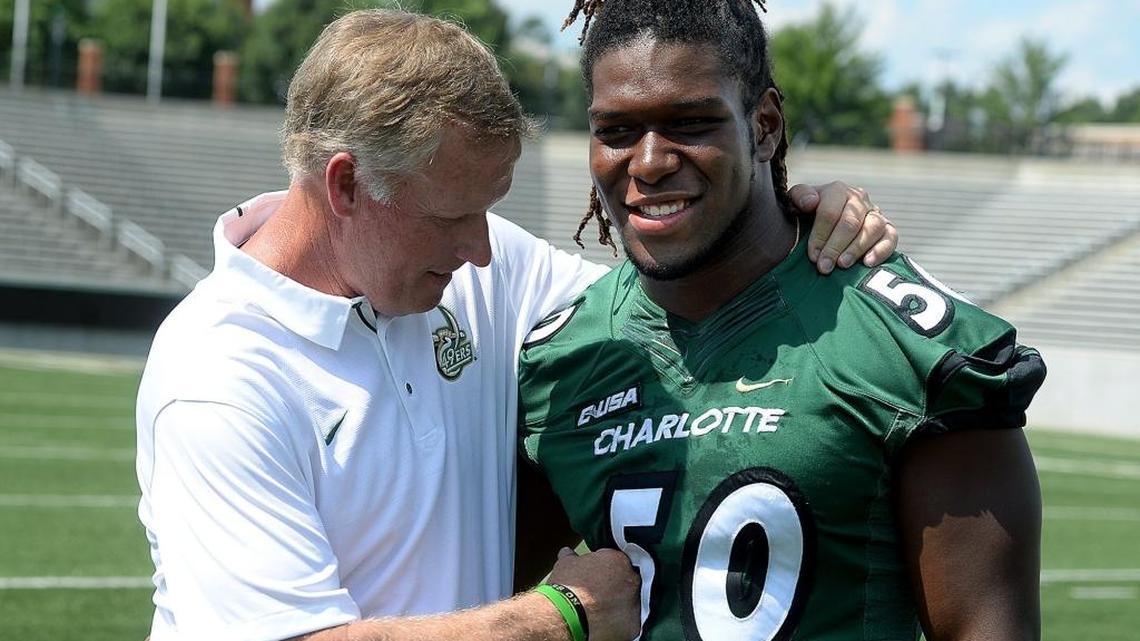 Coach Brad Lambert and linebacker Karrington King at Charlotte 49ers football media day at Richardson Stadium. King finished with 10 tackles Friday and needs two more to tie the school record of 217.