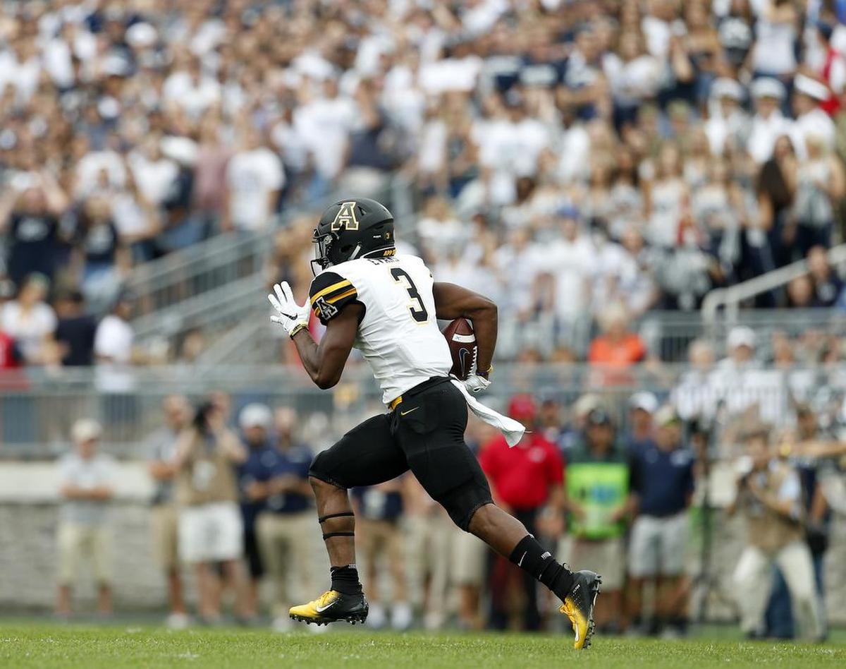 Appalachian State’s Darrynton Evans runs back a kick for 100 yards against Penn State during the first half Saturday in State College, Pa. Penn State outlasted the Mountaineers 45-38 in overtime.