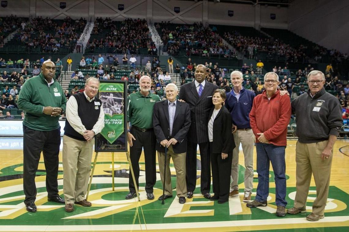 The 1976-77 Final Four team, including Cedric Maxwell in the suit at center, was honored at halftime of a Charlotte 49ers game in 2017. Coach Lee Rose is standing to the left of Maxwell, holding a cane.