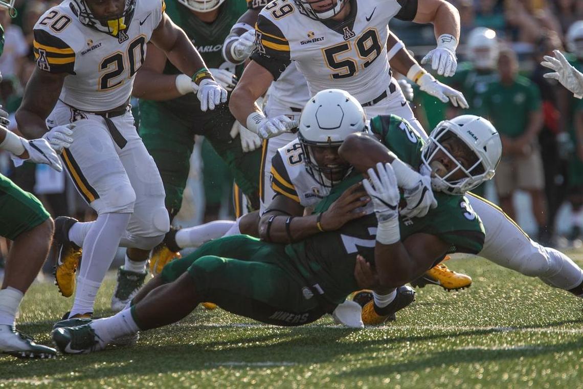 Charlotte 49ers running back Benny LeMay (32) is tackled by Appalachian State linebacker Trey Cobb (45) in the first half of Saturday’s college football game at Richardson Stadium. Appalachian State won 45-9.