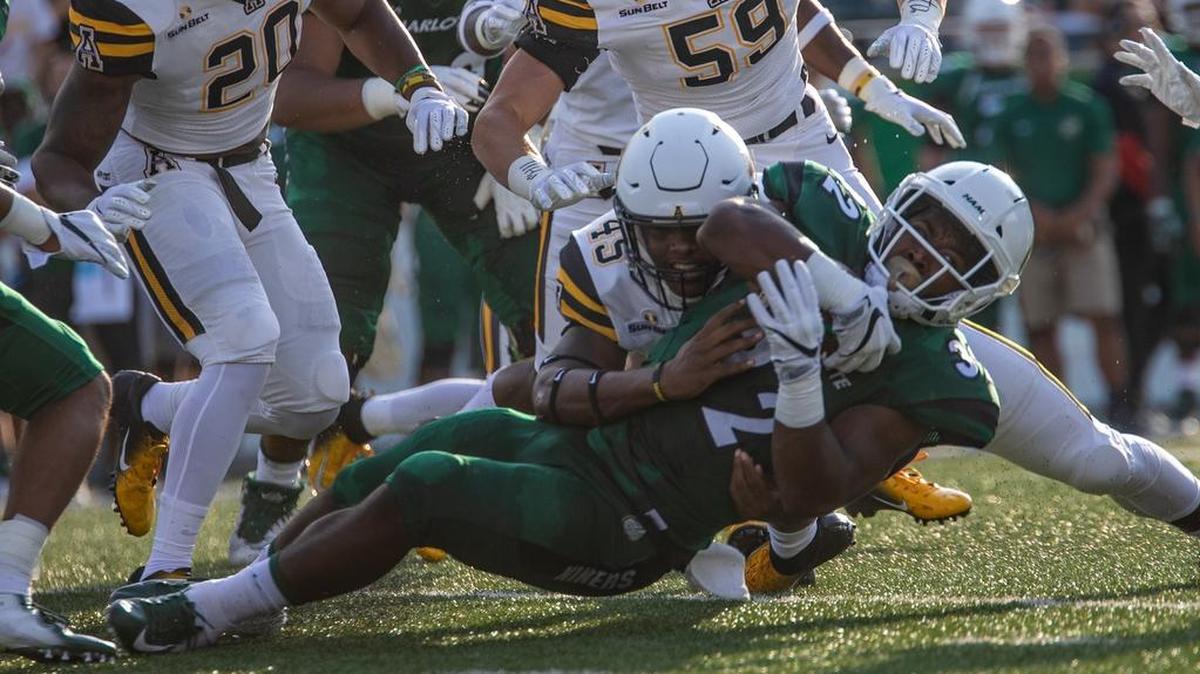 Charlotte 49ers running back Benny LeMay (32) is tackled by Appalachian State linebacker Trey Cobb (45) in the first half of Saturday’s college football game at Richardson Stadium. Appalachian State won 45-9.