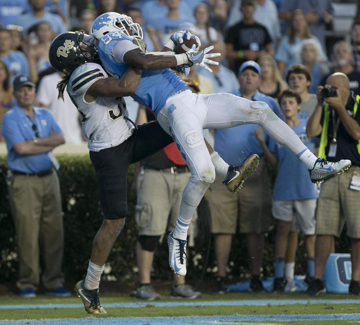 North Carolinas Bug Howard (84) goes over Pittsburghs Ryan Lewis (38) and pulls down a two yard pass from quarterback Mitch Trubisky for the game winning touchdown, leading the Tar Heels to a 37-36 victory on Saturday, September 24, 2016 at Kenan Stadium in Chapel Hill, N.C.