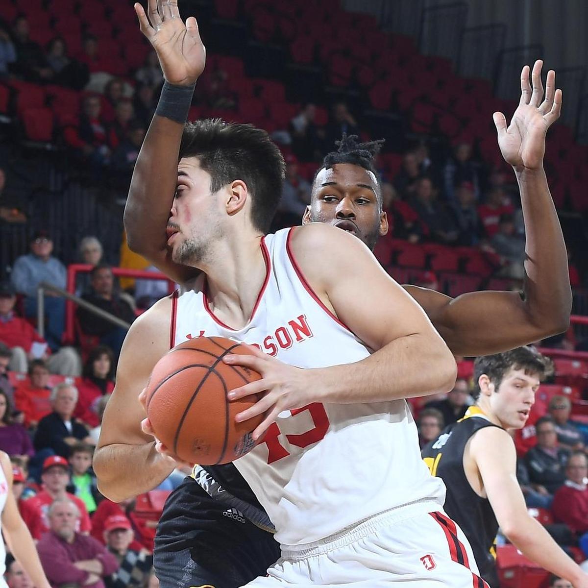 Davidson’s Dusan Kovacevic, left, is fouled by Winthrop’s Jermaine Ukaegbu at Belk Arena on Tuesday.