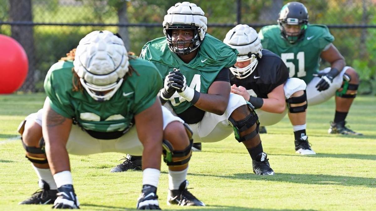 Charlotte 49ers offensive guard Nate Davis (second from left) goes through stretching drills before Wednesday’s practice. Davis, a 6-foot-3, 300-pound redshirt sophomore, has caught the attention of NFL scouts.