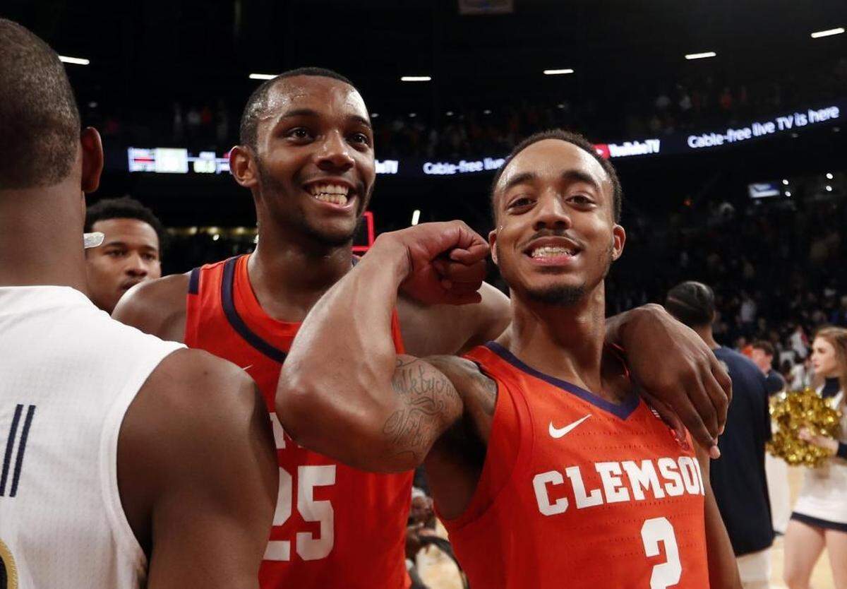 Clemson guard Marcquise Reed (2) gestures as he leaves the court with teammate Clemson forward Aamir Simms (25) after defeating Georgia Tech Sunday night in Atlanta.