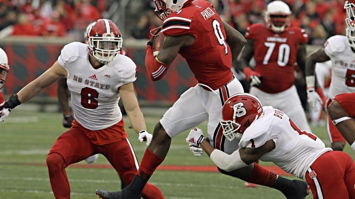 
Louisville wide receiver DeVante Parker (9) works to elude North Carolina State tacklers Jarvis Byrd (1) and Tim Buckley (6) after a pass reception in their NCAA college football game, Oct. 18, 2014 in Louisville, Ky. Louisville beat North Carolina State 30-18. 
