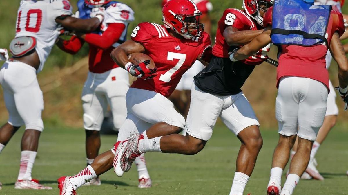 
N.C. State freshman Nyheim Hines (7) runs the ball at N.C. State football practice in Raleigh on Aug. 12, 2015. 
