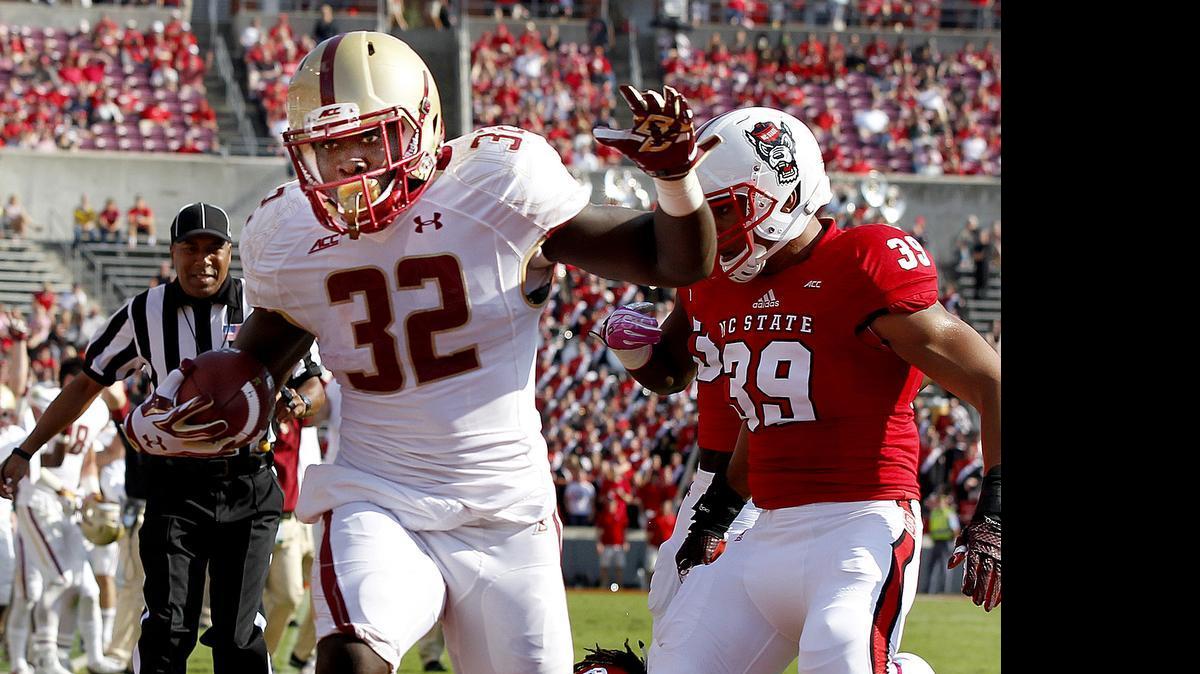 
Boston College's Jon Hilliman (32) runs in for a 10-yard touchdown during the first half of N.C. State's game against Boston College at Carter-Finley Stadium in Raleigh,  Oct. 11, 2014.
