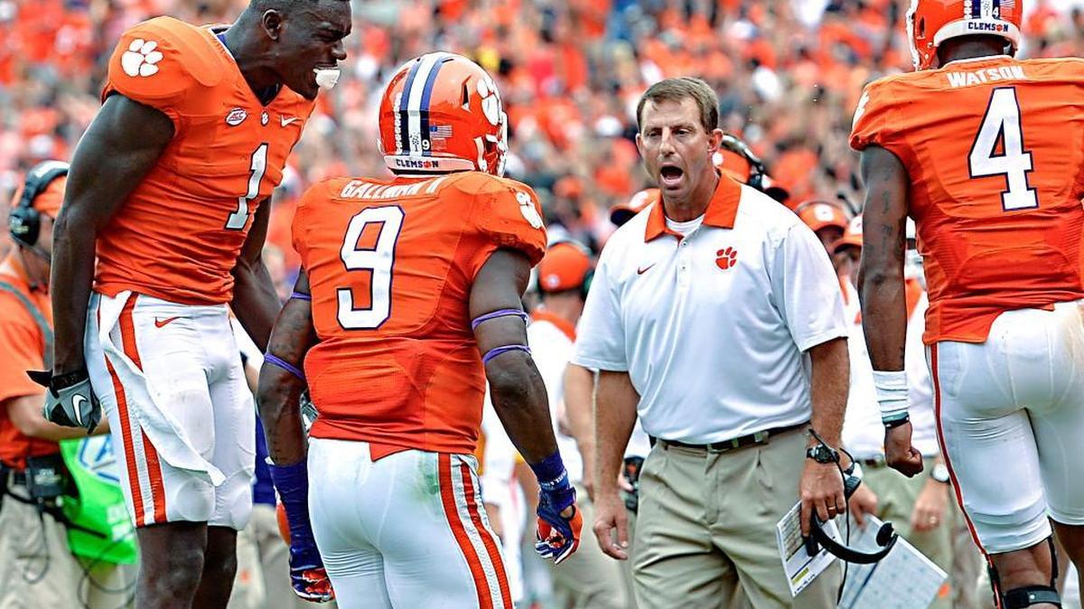 
Clemson head coach Dabo Swinney, along with Deshaun Watson, right, and Jayron Kearse celebrate Charone Peake's touchdown during the second half of an NCAA college football game against Appalachian State Saturday, Sept. 12, 2015, in Clemson, S.C. Clemson won 41-10. 
