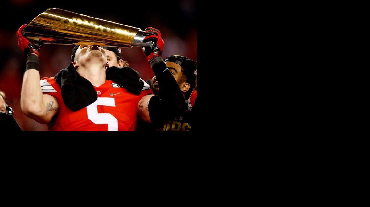 
Ohio State linebacker Raekwon McMillan celebrates with the trophy after the Buckeyes beat the Oregon Ducks, 42-20, to win the first College Football Playoff National Championship Game at AT&T Stadium on Jan. 12, 2015 in Arlington, Texas. 
