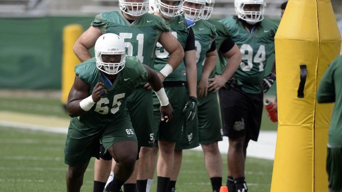 Charlotte’s Larry Ogunjobi, left, is the 49ers’ career leader in tackles. A senior nose tackle from Greensboro, he is on the watch list for the Bednarik Award, presented annually to college football’s defensive player of the year.