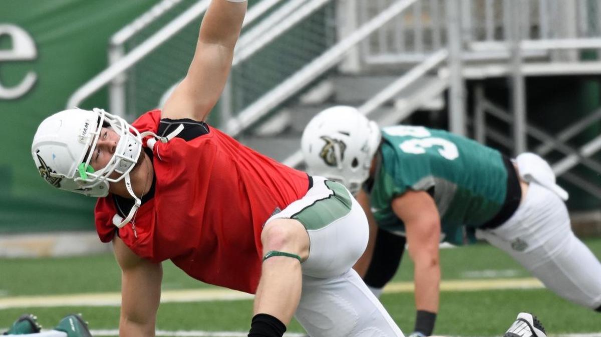 Charlotte senior linebacker Nick Cook stretches before the start of the 49ers’ spring practice on Thursday, April 7, 2016, at Richardson Stadium.