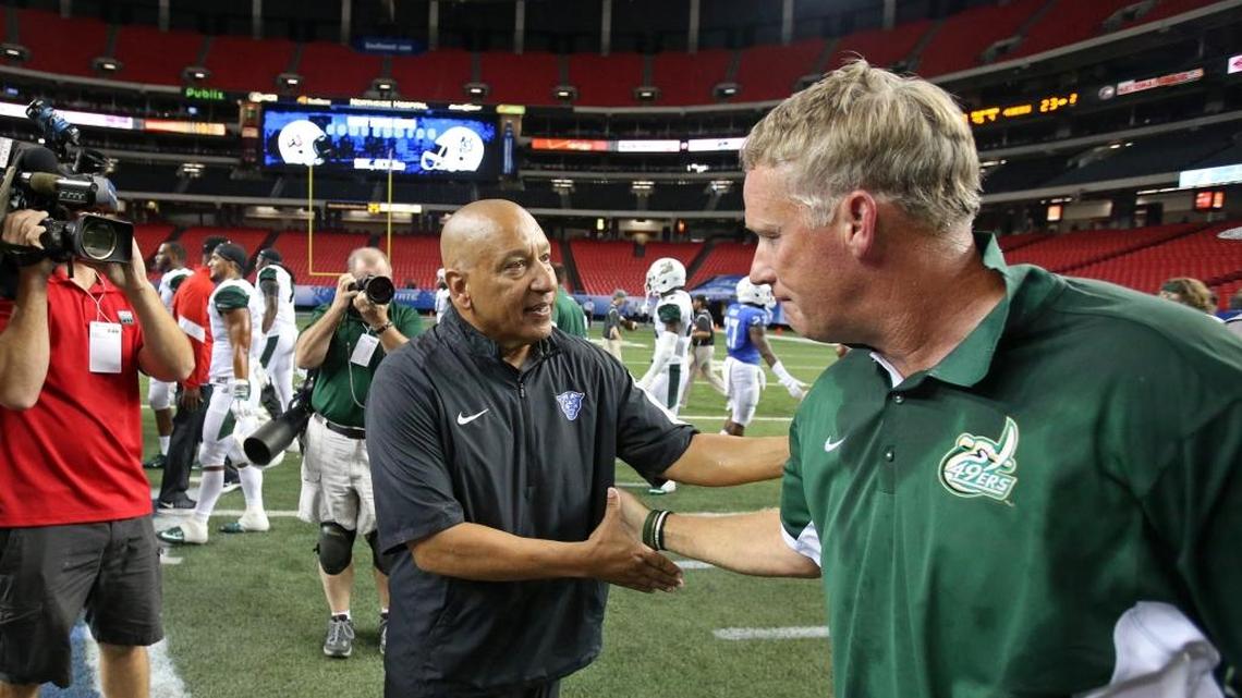 
Georgia State head coach Trent Miles, left, greets Charlotte head coach Brad Lambert after Charlotte's 23-20 win at the Georgia Dome in Atlanta, on Friday, Sept. 4, 2015. Charlotte won, 23-20.
