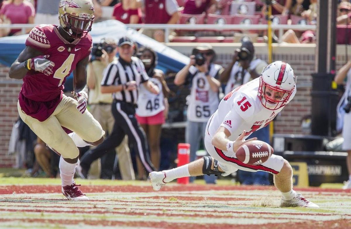 North Carolina State quarterback Ryan Finley chases a bobbled snap through the end zone giving Florida State defensive back Tavarus McFadden and the Seminoles a touchback in the second half of an NCAA college football game in Tallahassee, Fla., Saturday, Sept. 23, 2017. NC State defeated Florida State 27-21. (AP Photo/Mark Wallheiser)