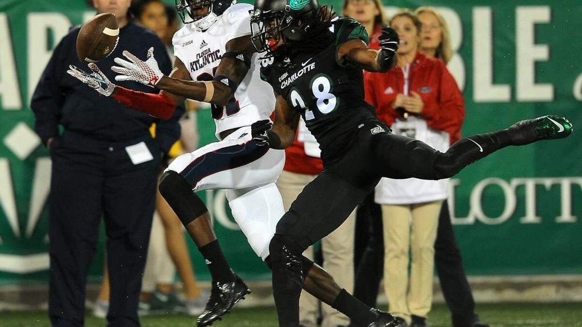 
Florida Atlantic wide receiver Kalib Woods, left, is unable to make a pass reception as Charlotte 49ers defensive back Greg Cunningham Jr., right, applies pressure during second quarter action at Jerry Richardson Stadium on Saturday, Sept. 26, 2015.
