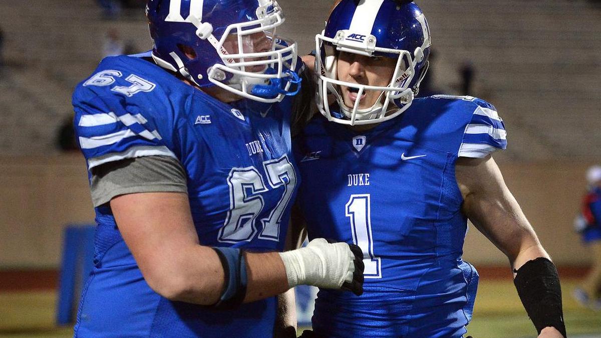 
Duke quarterback Thomas Sirk (1) is congratulated by guard Lucas Patrick (67) after throwing a fourth quarter touchdown against Wake Forest at Wallace Wade Stadium Saturday, Nov. 29, 2014 in Durham, NC.
